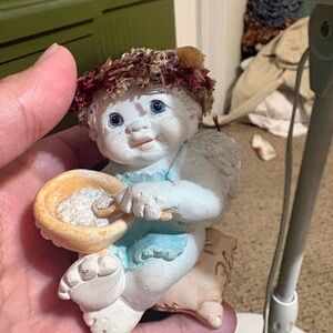 Cherubic Angel Figurine sitting on flour